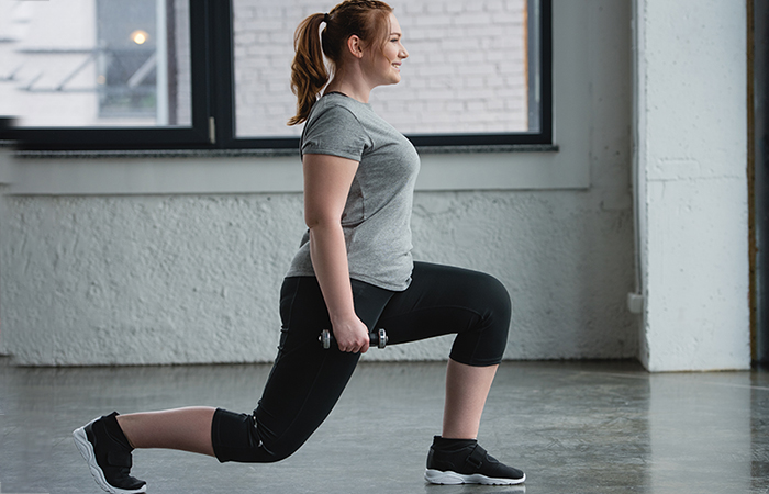 A woman doing lunges to strengthen her quads