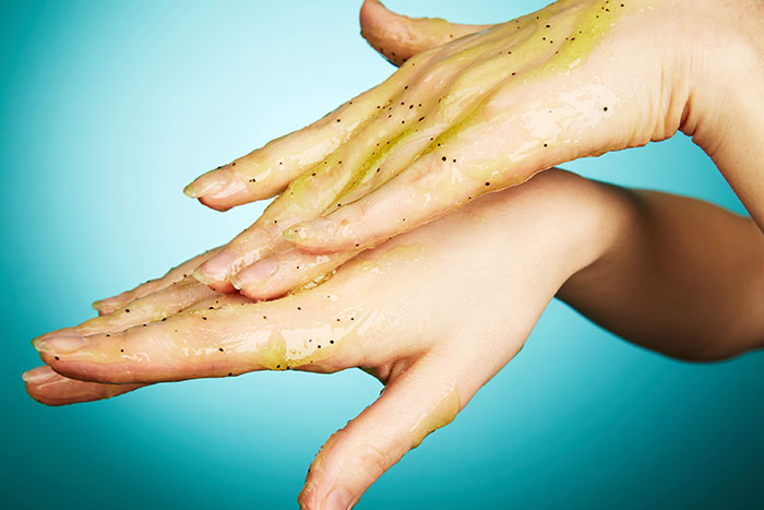 Scrubbing with a face exfoliator to remove mehndi