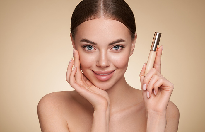 Close up of a woman holding a primer bottle