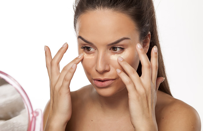 Woman applying primer before makeup for gold dress