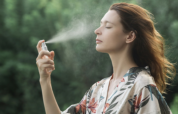 Woman applying face mist